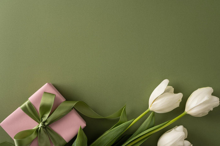 Luxury Mother’s Day gift boxes with fragrance, candle, body care, and sweet treats in elegant packaging paired with flowers