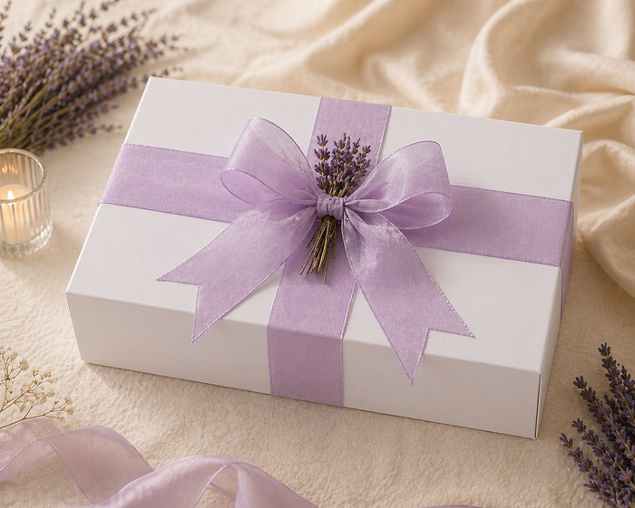 Luxury Mother’s Day gift boxes with fragrance, candle, body care, and sweet treats in elegant packaging paired with flowers